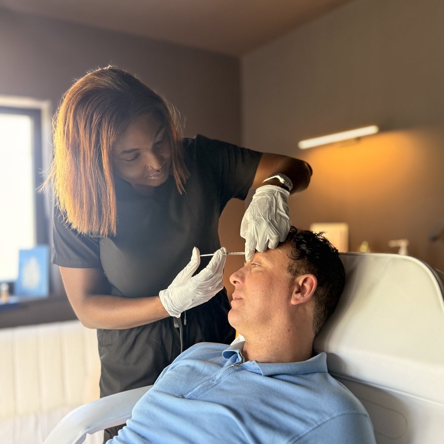 Dr Tafadzwa performing doctor-led anti-wrinkle treatment on a male patient in Limerick